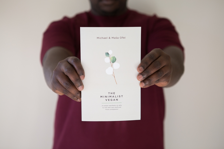 Michael holding a copy of The Minimalist Vegan book