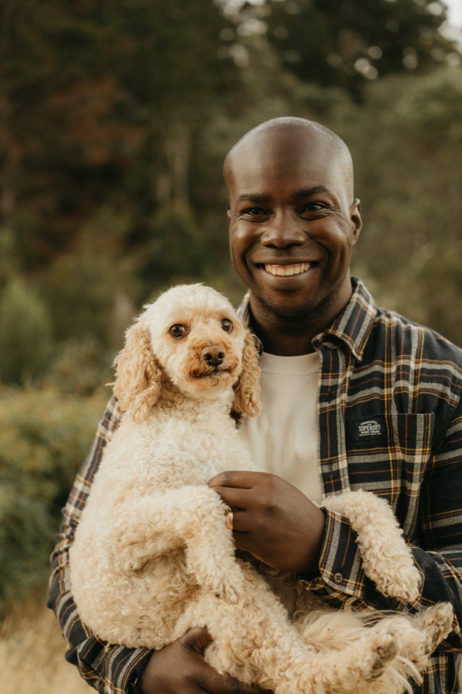 Michael Ofei holding his dog