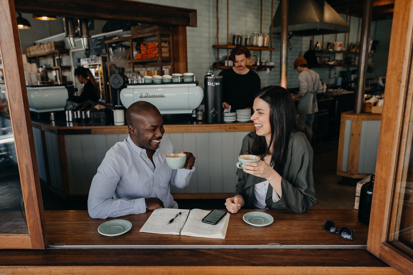 Michael Ofei and Maša Ofei sharing coffee at a café